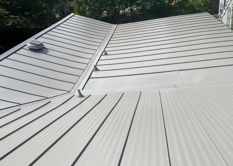 Solar attic fan installed on a metal roof for Roof Ventilation in Fort Stewart